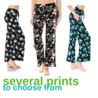 Three women wearing the Buttery Soft Pajama Pants with Drawstring by FASHION GO are seen sporting a variety of patterns—panda, pink floral, and blue paw prints. The pants feature an elastic waistband and come with the phrase "several prints to choose from" displayed in green.