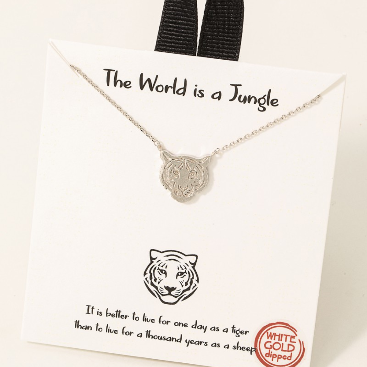 FASHION GO's Gold Dipped Tiger Head Pendant Necklace displayed on a card with the words "the world is a jungle" and a quote about living boldly.