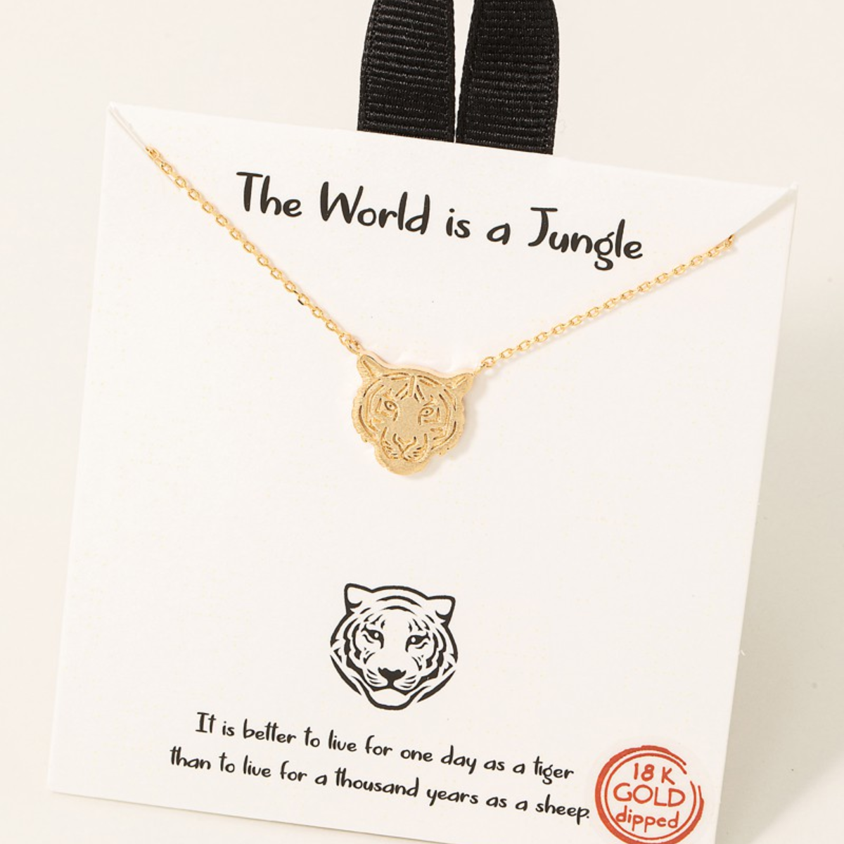 Gold Dipped Tiger Head Pendant Necklace from FASHION GO displayed on a card with the phrase "the world is a jungle" and the quote "it is better to live for one day as a tiger than to live for a thousand years". Main image