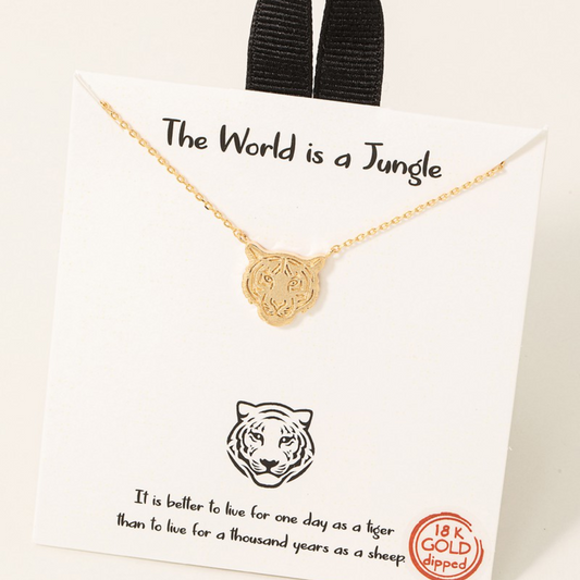 Gold Dipped Tiger Head Pendant Necklace from FASHION GO displayed on a card with the phrase "the world is a jungle" and the quote "it is better to live for one day as a tiger than to live for a thousand years".