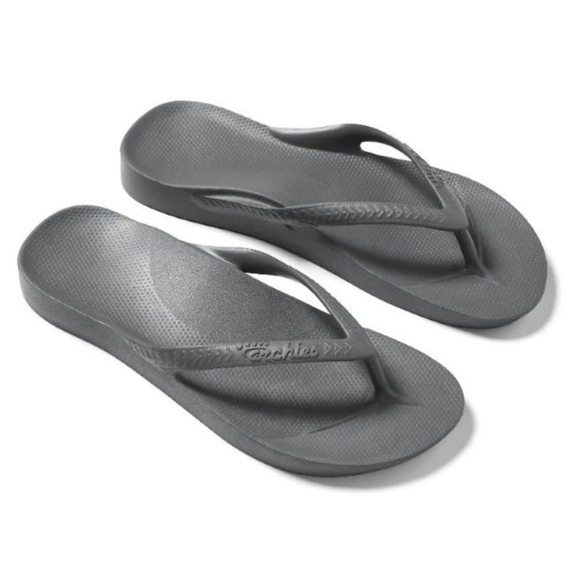 A pair of black ARCHIES Flip Flops in CHARCOAL by ARCHIES FOOTWEAR LLC on a white background. Main image