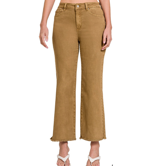 A woman in Zenana acid washed high waisted frayed hem camel pants with stretch fabric.