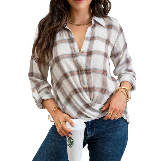 A woman wearing a MINE PLAID BUTTON UP WRAP WOVEN TOP and jeans holding a cup of coffee.