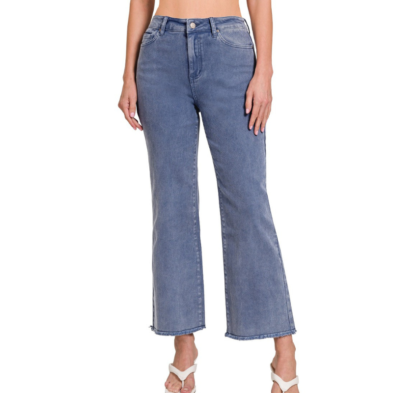 A woman wearing a pair of Zenana ACID WASHED FRAYED HEM PANTS made of stretch fabric.