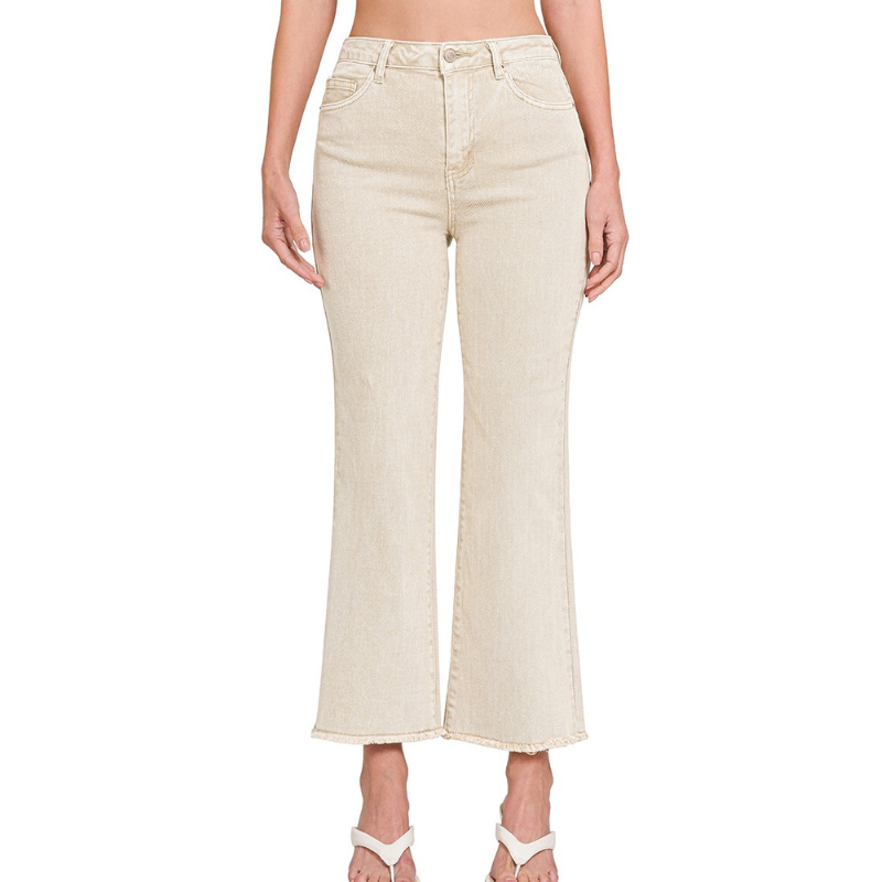 A woman wearing a pair of Zenana ACID WASHED FRAYED HEM PANTS beige with stretch.